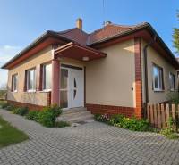 A family house in Križovany nad Dudváhom with a landscaped garden and a paved walkway.
