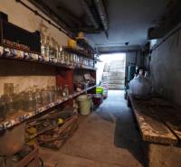 Basement of a family house with shelves full of canning jars and other equipment.