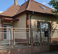 A family house in Križovany nad Dudváhom with a brick fence and a sloped roof.