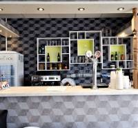 A bar counter with drinks and beer taps in commercial premises.