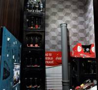 Storage space in commercial premises with bottles and pipes.
