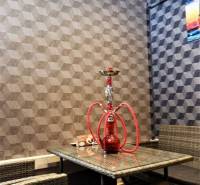 In the commercial space, you can see rattan furniture, a glass table, and a hookah on a geometric wallpaper.