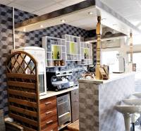 Interior of commercial spaces with a bar counter, decorative walls, and bar stools.