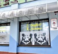 The exterior of commercial premises in Šaľa with graphic silhouettes and advertising for Lavazza coffee.