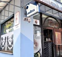 The exterior of commercial premises in Šaľa with café motifs on the display window.