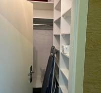 Storage space with a wardrobe and shelves in a 4-room apartment.