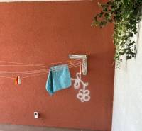 Balcony of a 4-room apartment with a colorful wall, white graphite, and wooden decor flooring.