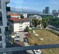 View of the surroundings from the apartment on Jégého, Bratislava - Nivy, parking lot, buildings.
