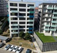 View of modern apartment buildings with parked cars on Jégého Street, Bratislava - Nivy.