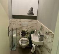 A bathroom in a 4-room apartment with marble tiles and a modern sink.