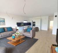 Living room in a family house with a wooden decor floor, sofa, and decorations.
