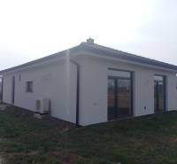 A family house in Galanta with a white facade and windows with glass blocks.