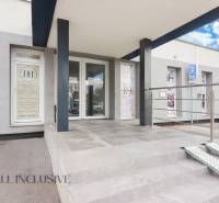 Entrance to commercial premises on Vajanského Street, with wheelchair access and a parking space.