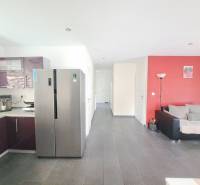 A kitchen with purple cabinets and a gray floor in a family house.