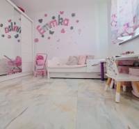 Children's room in a family house with decorations, furniture, and toys, floor with wooden decor.