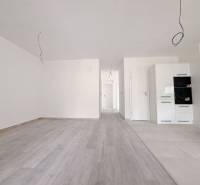 The interior of a family house with white walls and a floor with a wood decor.