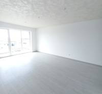 A bright room with a wood-decor floor in a 2-room apartment.