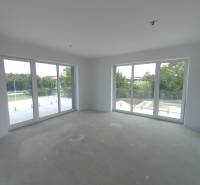 Large windows and natural light in a 2-room apartment, offering a view of greenery.