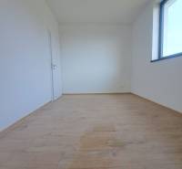 Interior of a family house with a bright room, wooden decor flooring, large window.