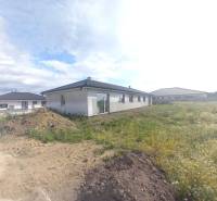 A family house in Galanta surrounded by adjacent land and other houses.