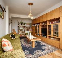 Living room in a 3-room apartment with a carpet and a wooden decor floor.