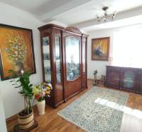 Living room in a family house with a carpet, cabinet, and floor with a wooden decor.