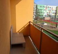 A balcony with a view of the school grounds and sports facilities from a 4-room apartment.