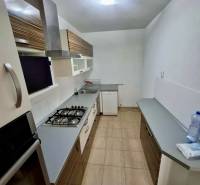 A kitchen in a 4-room apartment with a gas stove and storage space.