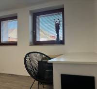 Wall with windows, window sills, table and chair, family house, floor with wooden decor.