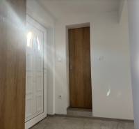 Interior of a family house with white doors and a floor with a wooden decor.