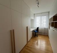 A study room in a 3-room apartment with a wooden decor floor and built-in furniture.