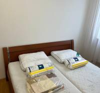 Bedroom with a double bed, wooden decor flooring, 3-room apartment.