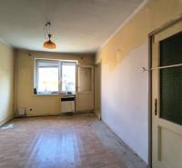 A room in a family house with a window, doors, and a floor.