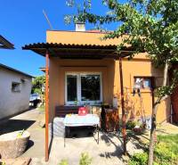 A family house in Partizánske with a terrace and a tree in the yard.