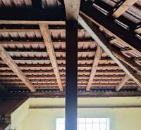 Roof structure with tiles and wooden beams in a family house.