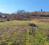A plot of land near a family house in Tachtá with a rural landscape and a lookout tower on the hill.