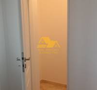 Interior of a 2-room apartment with open doors and a wooden decor floor.