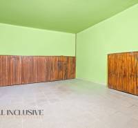 Green walls and wooden paneling in the interior of a family house.