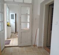 Interior of a family house with white doors and tiled floor.
