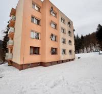 An apartment building in the snowy environment of Oščadnica offers affordable living in 2-bedroom apartments.