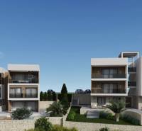 Recreational apartments in the city of Ciovo with contemporary architecture, surrounded by greenery and stone walls.