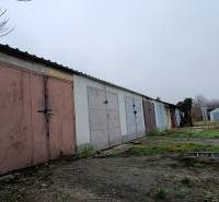 Garages on Fabrická Street in Nitra, surrounded by grass and concrete surfaces.