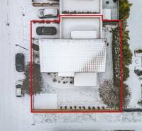 Aerial view of a snow-covered family house with a plot on Konopiská Street in Bratislava - Čunovo.