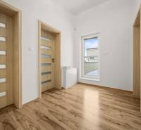 Interior of a family house with a wooden decor floor and doors with glazing.
