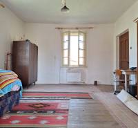 A room in a family house with carpets and a bookshelf, floor with wooden decor.