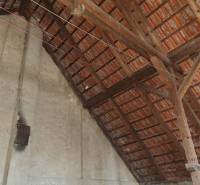 The attic of a family house with wooden beams and ceramic roof tiles in Orávka.