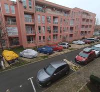 Recreational apartment in Burgas with parked cars in front of a pink building.