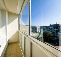 Enclosed balcony of a 2-room apartment in Bratislava - Vajnory with a view of the housing estate.