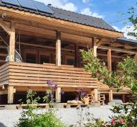 Wooden cottage on Hviezdoslav Street in Tisovec with a wooden terrace and garden.