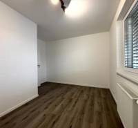 A bright room with a wooden decor floor in a 3-room apartment.